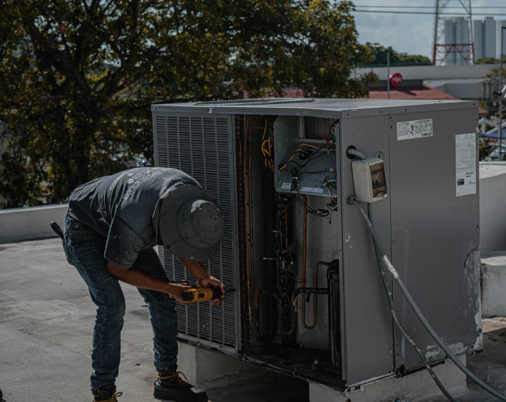 HVAC Contractor Working on AC Unit