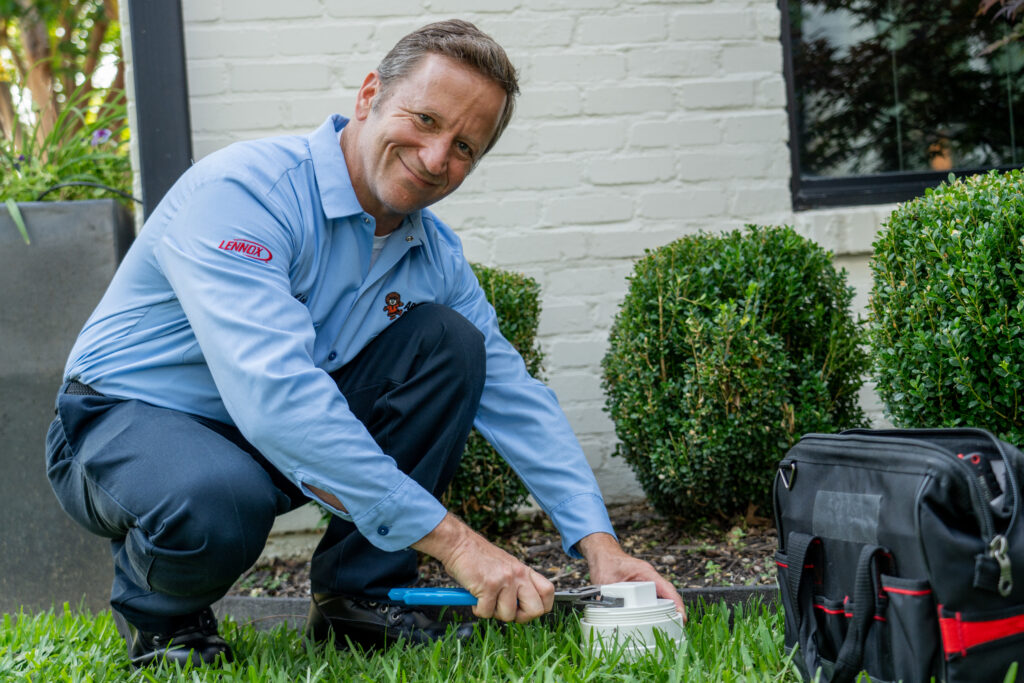 Local plumber working on outside system