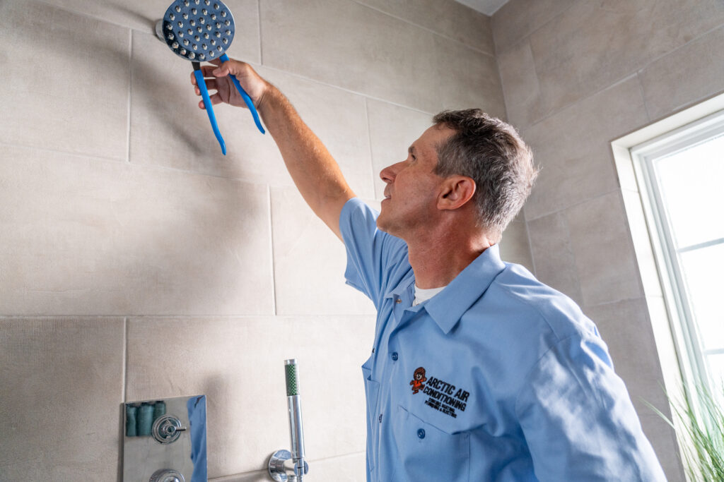 Arctic Air plumber installing a shower head