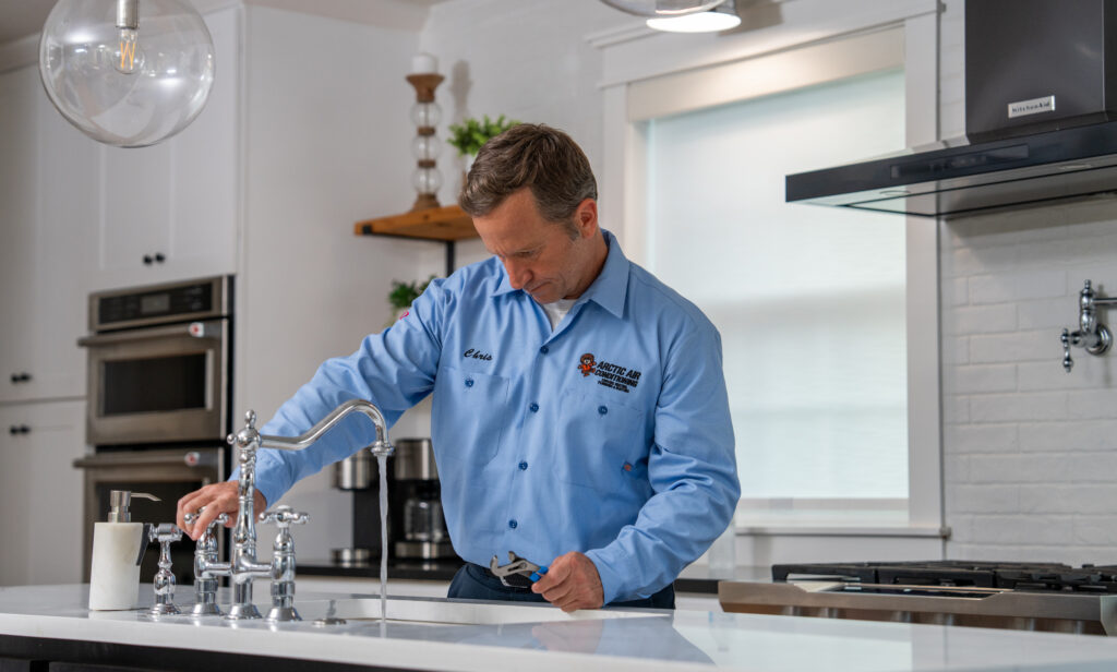 Plumbing Services Specialist Working on Faucet