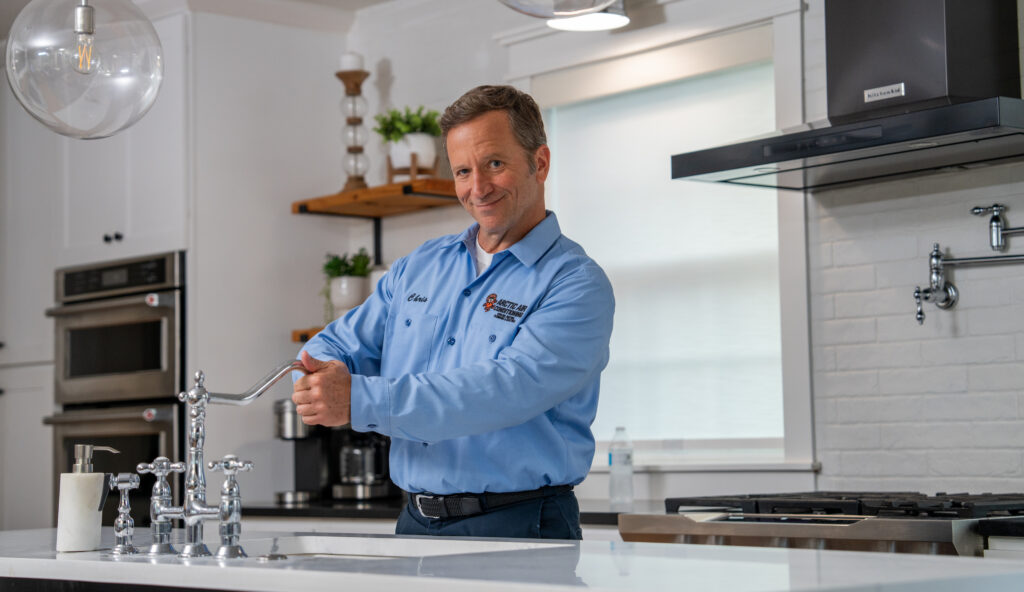 Arctic Air Plumber working on kitchen sink