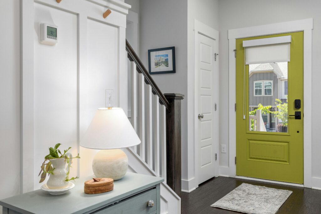 hallway with thermostat and green entry door