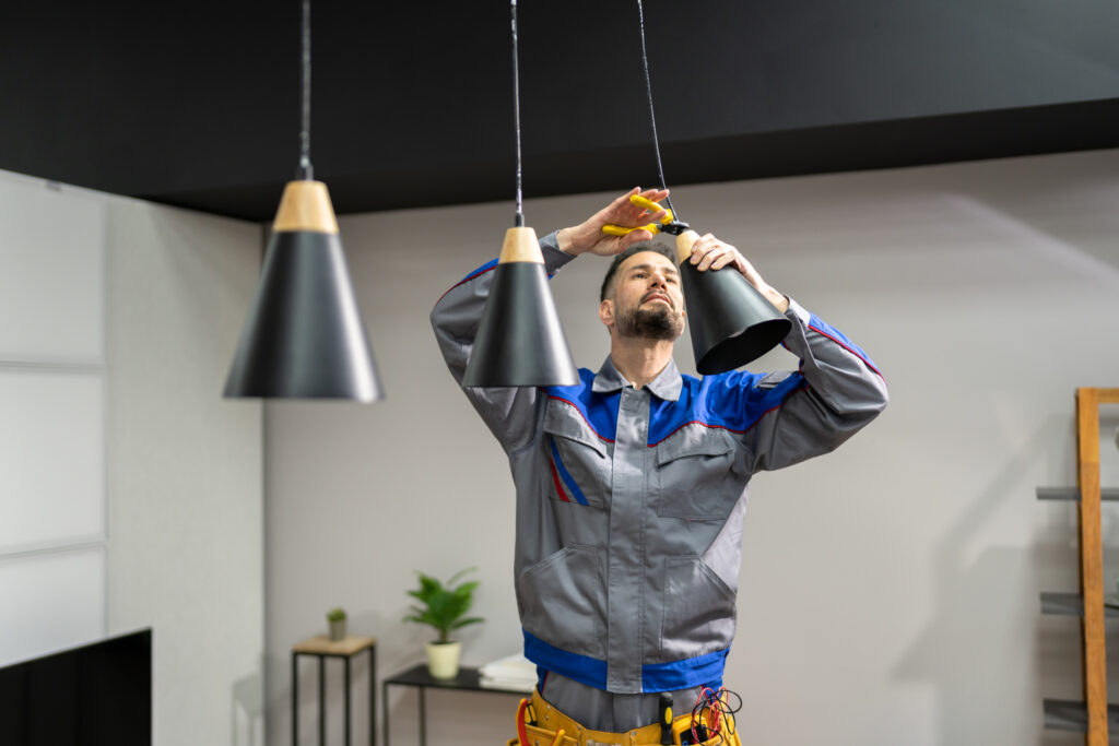 Electrician installing a pendant light fixture