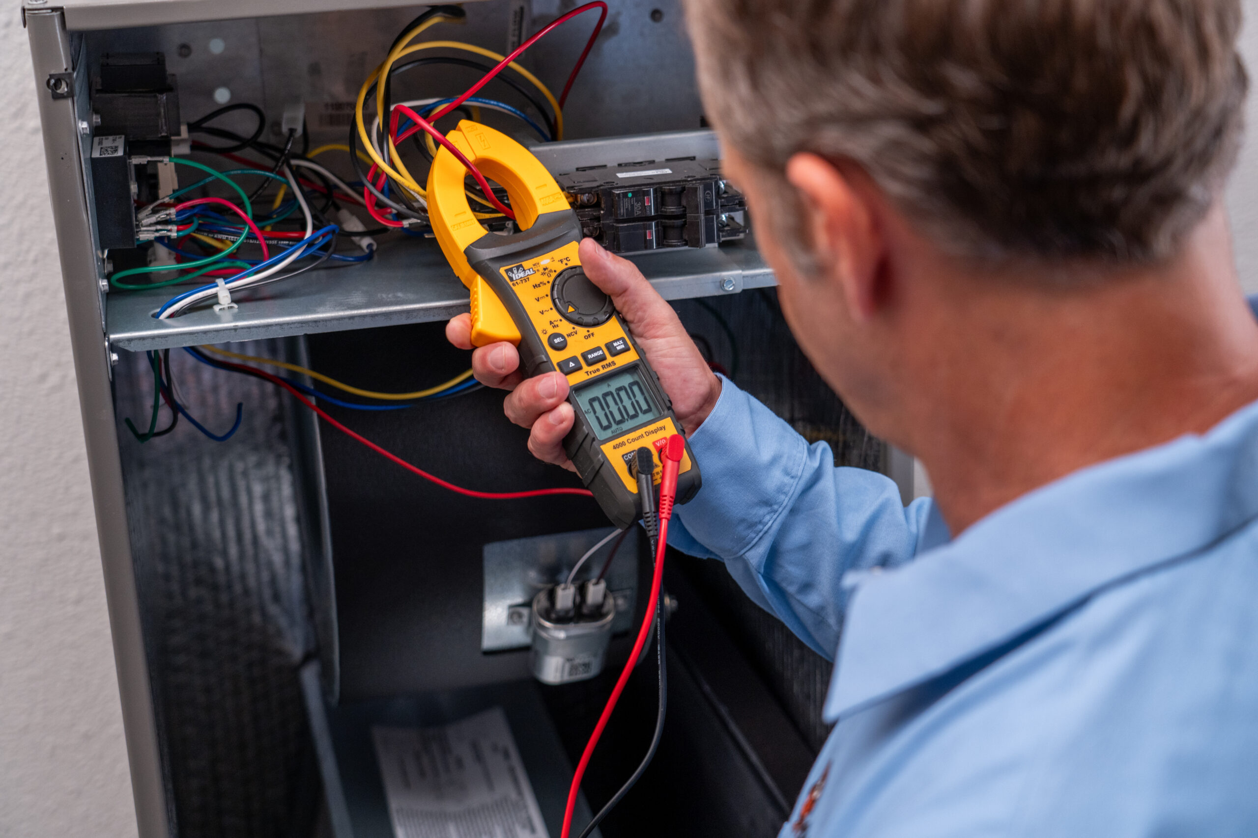 HVAC Tech with a Tool Testing an HVAC Unit