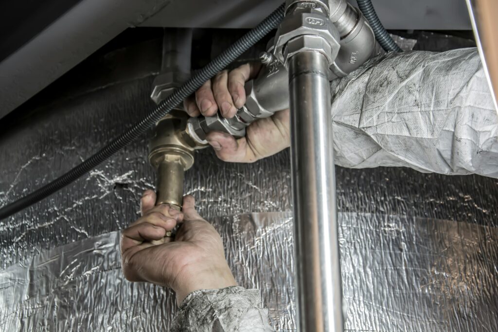 plumber working on pipes